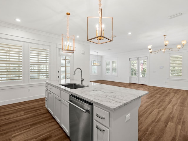 kitchen featuring sink, white cabinetry, a kitchen island with sink, decorative light fixtures, and stainless steel dishwasher