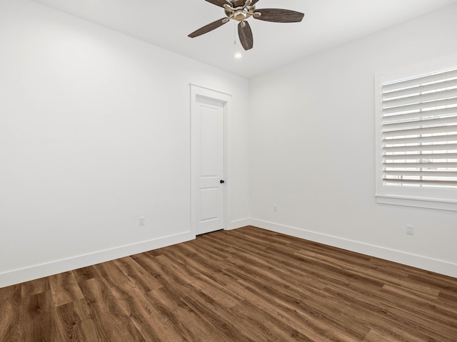 spare room with dark hardwood / wood-style floors and ceiling fan