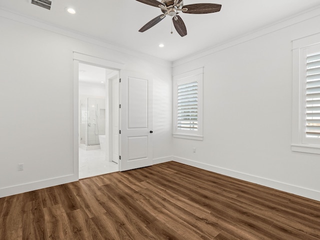 spare room with wood-type flooring, ornamental molding, and ceiling fan