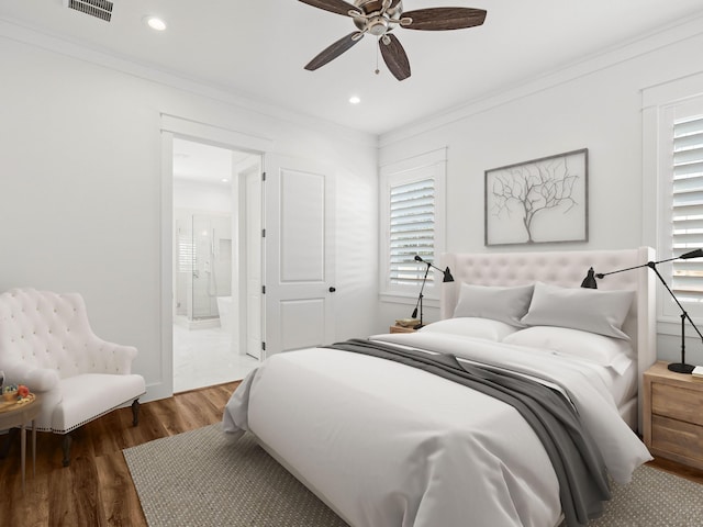 bedroom with ceiling fan, ornamental molding, dark hardwood / wood-style flooring, and ensuite bath