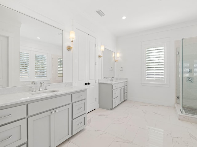 bathroom featuring vanity, crown molding, and a shower with shower door