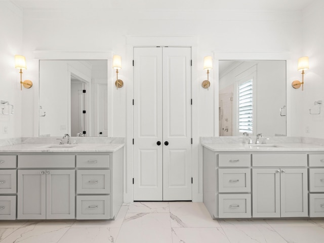 bathroom with ornamental molding and vanity