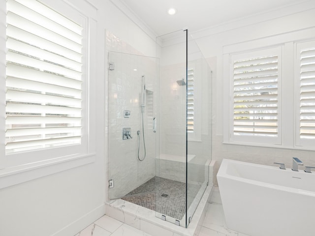 bathroom with crown molding and plus walk in shower