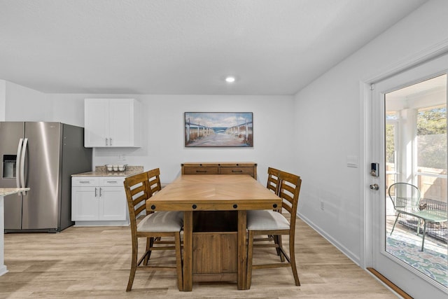 dining space with light hardwood / wood-style flooring