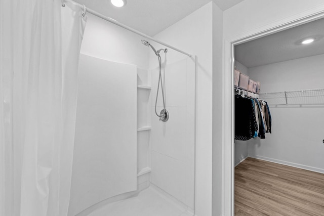 bathroom featuring a shower and hardwood / wood-style flooring