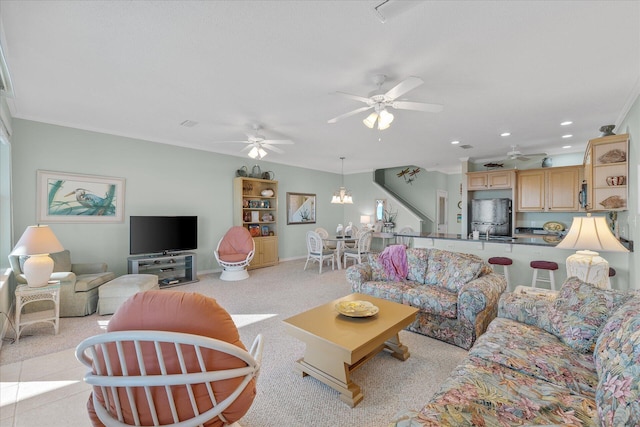 carpeted living room with ornamental molding and ceiling fan