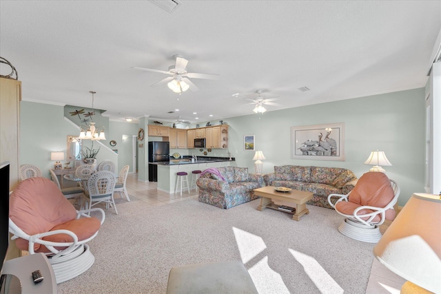 carpeted living room featuring ornamental molding and ceiling fan with notable chandelier