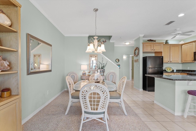 tiled dining space featuring crown molding and ceiling fan with notable chandelier