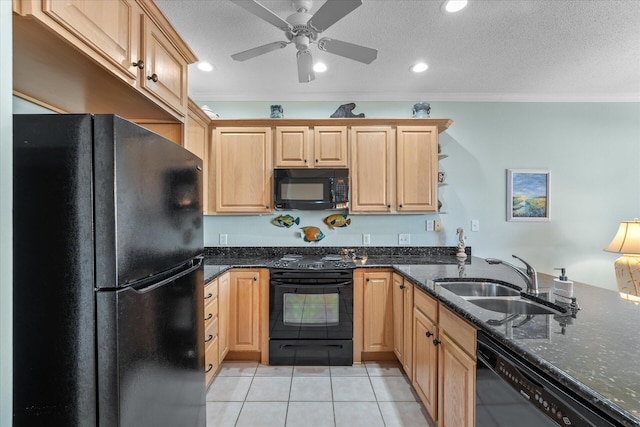 kitchen featuring sink, dark stone countertops, light tile patterned floors, black appliances, and crown molding