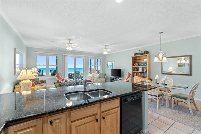 kitchen featuring sink, light tile patterned floors, dishwasher, dark stone countertops, and hanging light fixtures