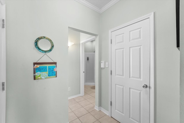 hall featuring ornamental molding and light tile patterned floors