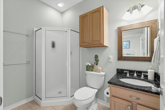 bathroom with tile patterned flooring, vanity, a shower with door, and toilet