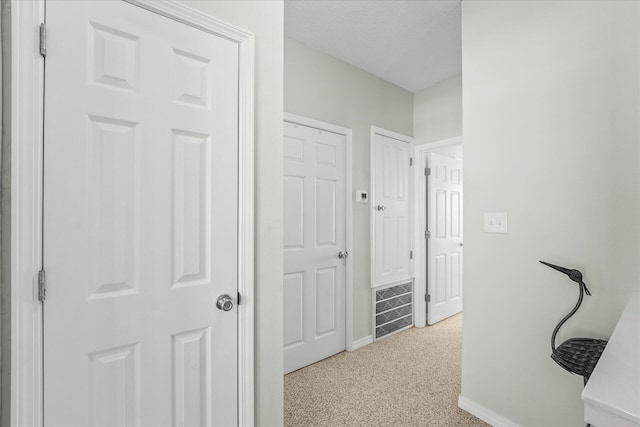 corridor with light colored carpet