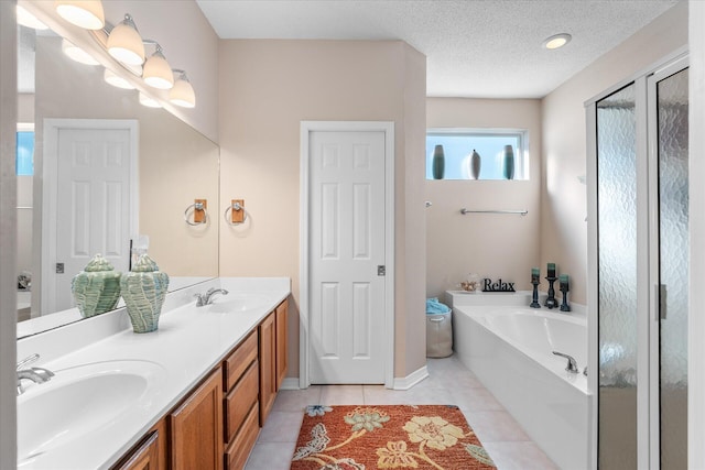 bathroom with vanity, tile patterned floors, a textured ceiling, and plus walk in shower