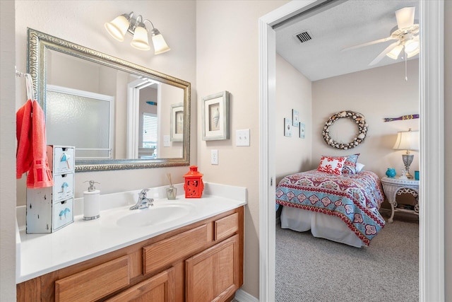 bathroom with ceiling fan and vanity