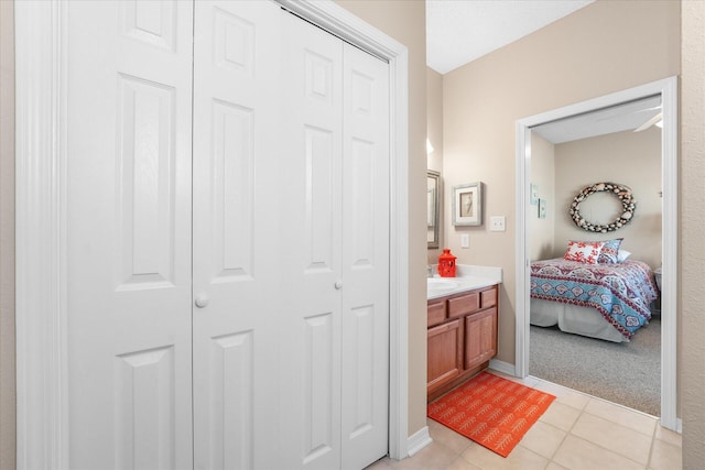 bathroom with tile patterned flooring and vanity