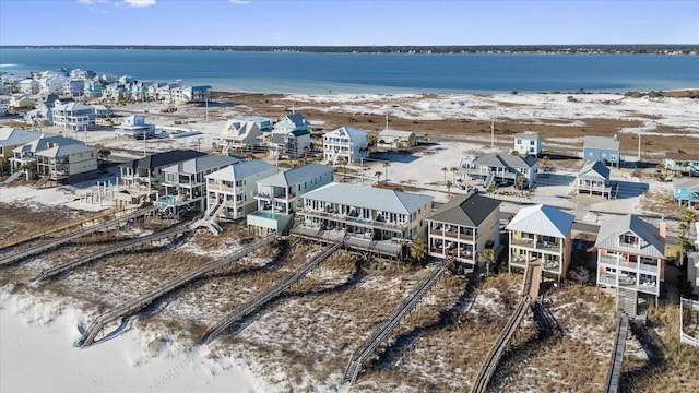 bird's eye view featuring a water view and a beach view