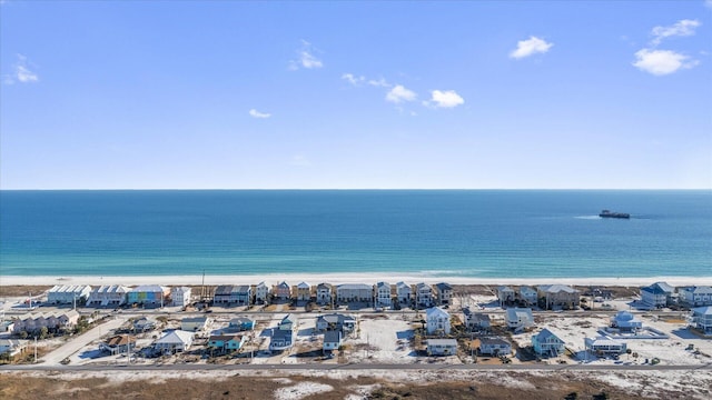 drone / aerial view with a water view and a beach view