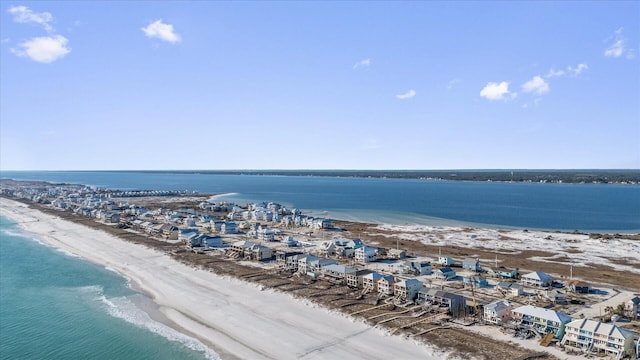 drone / aerial view with a water view and a beach view