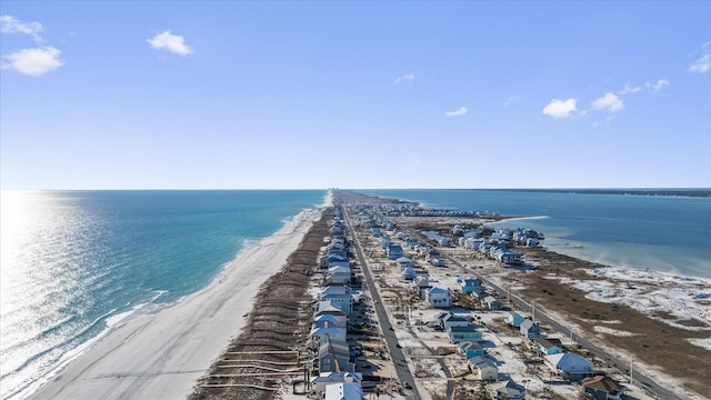 birds eye view of property with a water view and a beach view