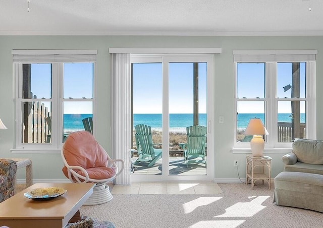 entryway featuring light tile patterned flooring, a water view, and a healthy amount of sunlight