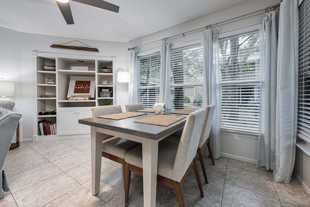 dining room with ceiling fan, a textured ceiling, and light tile patterned floors