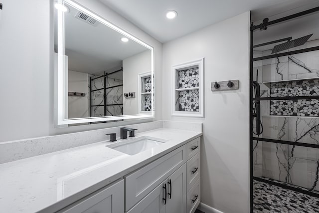 bathroom with walk in shower and vanity