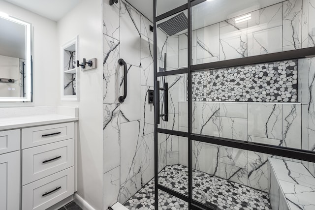 bathroom with vanity and a tile shower