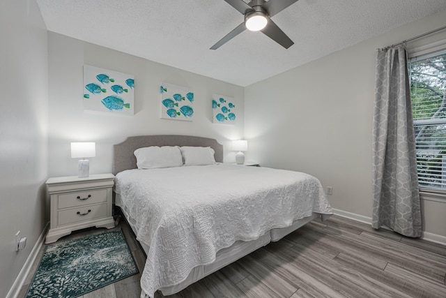 bedroom featuring a textured ceiling, light hardwood / wood-style flooring, and ceiling fan