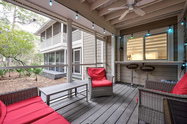 wooden deck with ceiling fan, an outdoor hangout area, and a sunroom