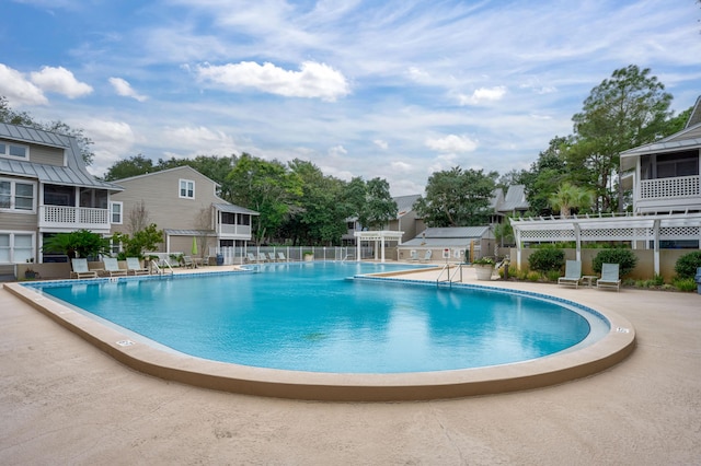 view of swimming pool featuring a patio and a pergola