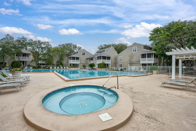 view of swimming pool with a pergola, a patio area, and a community hot tub