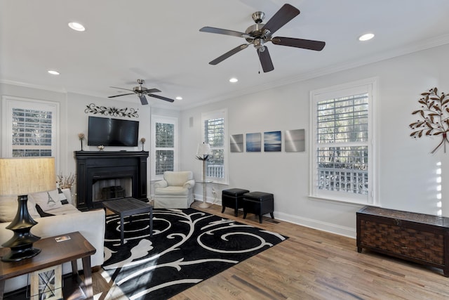 living room featuring hardwood / wood-style floors, plenty of natural light, and ornamental molding