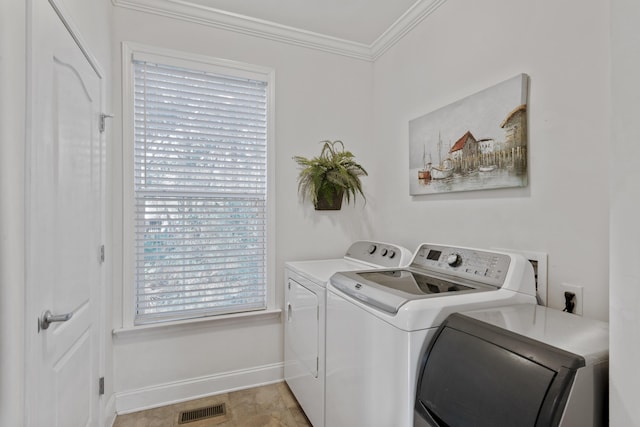 laundry area with independent washer and dryer and ornamental molding