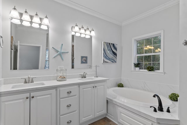 bathroom featuring tile patterned floors, ornamental molding, vanity, and a tub