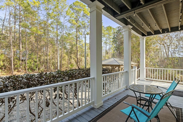 wooden terrace featuring a gazebo