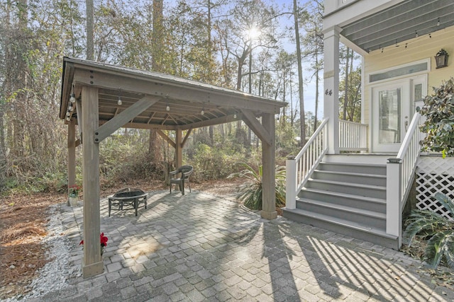 view of patio featuring a gazebo and an outdoor fire pit