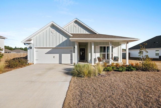 modern farmhouse with a porch and a garage