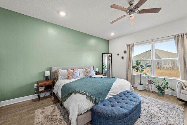 bedroom featuring hardwood / wood-style floors and ceiling fan