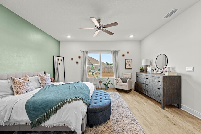 bedroom with ceiling fan and light hardwood / wood-style floors