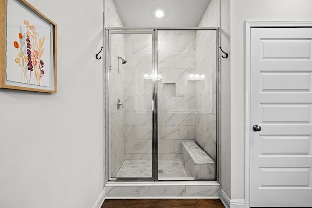 bathroom featuring a shower with shower door