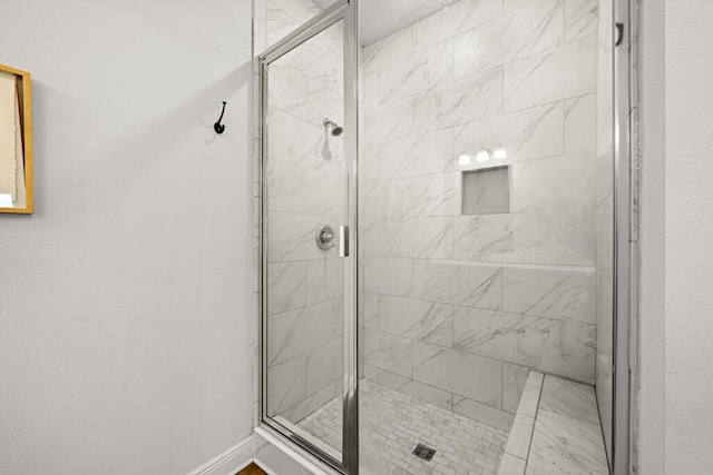 bathroom with a shower with door