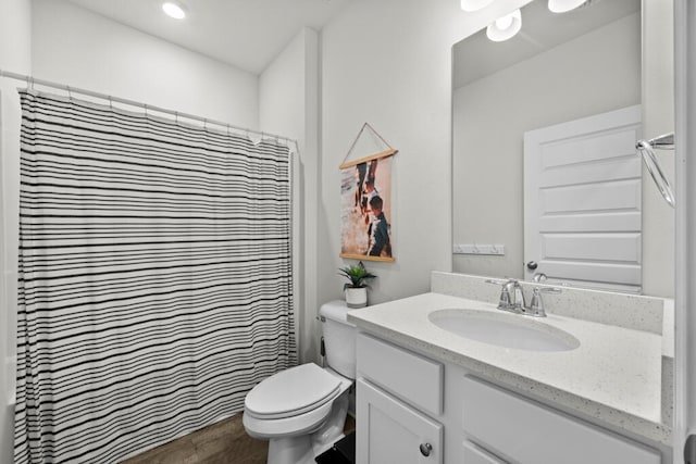 bathroom featuring hardwood / wood-style floors, toilet, vanity, and a shower with shower curtain