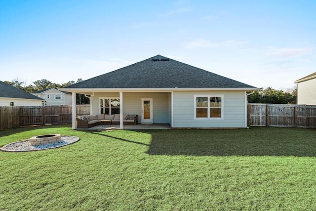 back of house featuring a patio area, a yard, and an outdoor living space with a fire pit