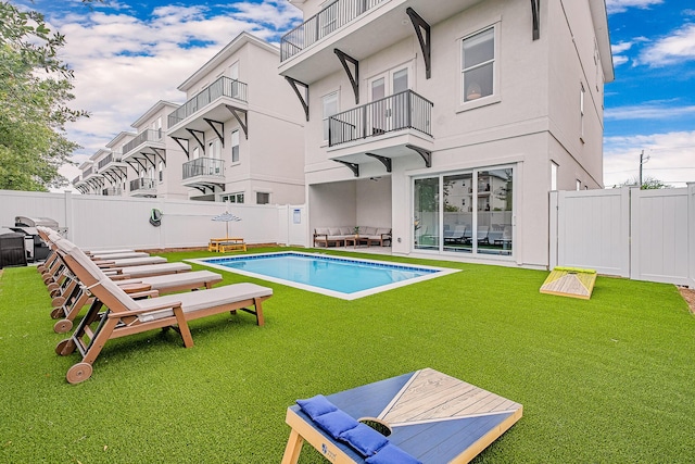 view of pool featuring a lawn