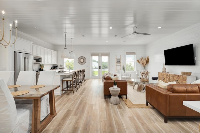 living room featuring ceiling fan and light hardwood / wood-style flooring