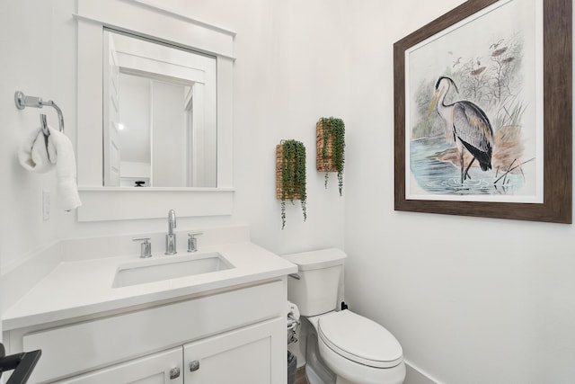 bathroom featuring toilet and vanity