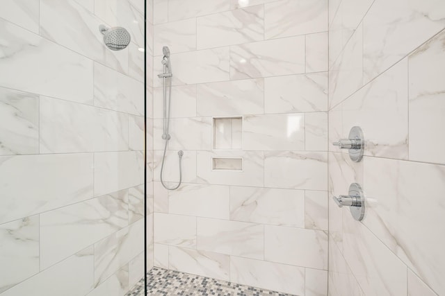 bathroom with a tile shower