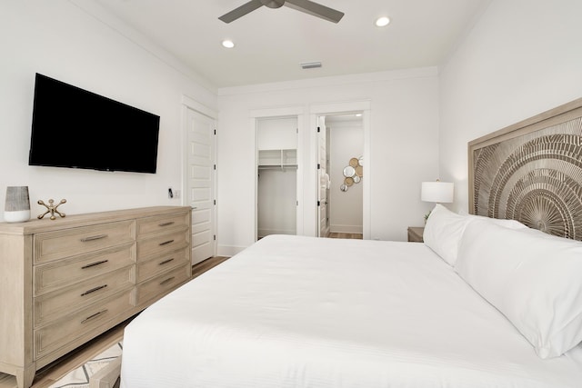 bedroom featuring ceiling fan, hardwood / wood-style flooring, and ornamental molding