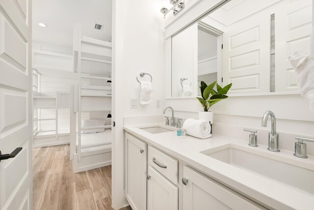 bathroom with vanity and wood-type flooring